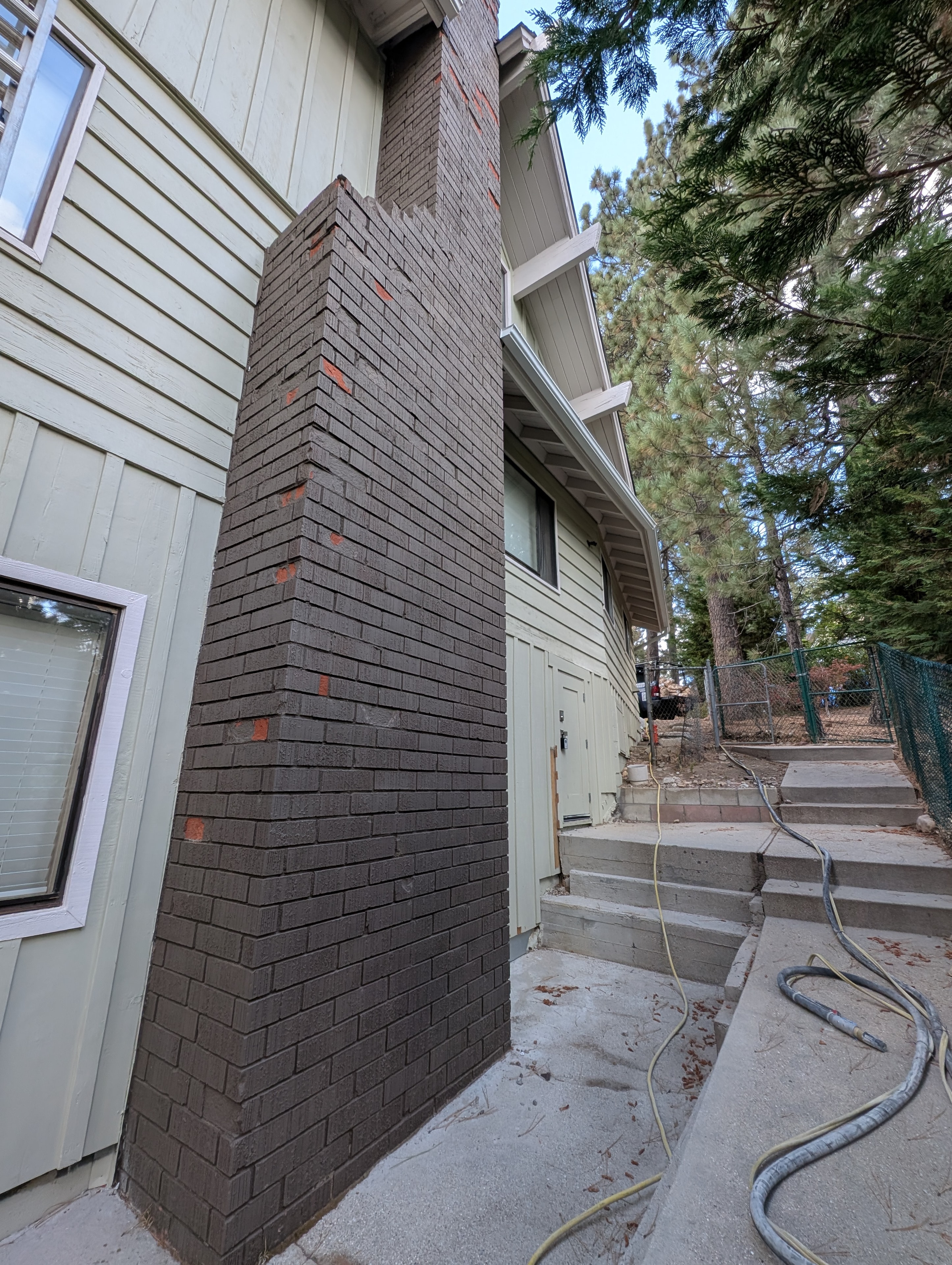 Soft media blasting underway on brick chimney, Big Bear CA
